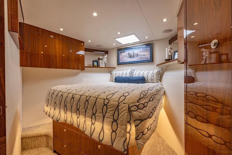 Slide: The Image of Luxurious bedroom interior of 2022 Viking 72 Convertible yacht with elegant wood finishes. - 57