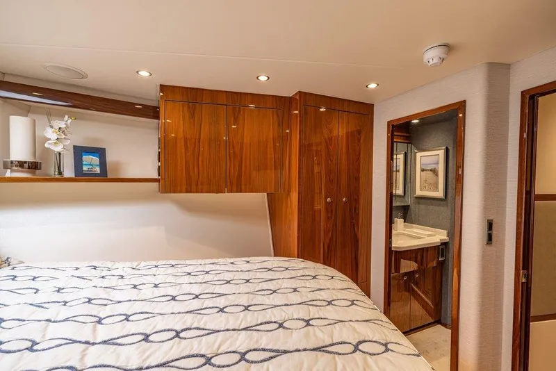 Slide: The Image of Luxurious bedroom interior of 2022 Viking 72 Convertible yacht with elegant wood finishes. - 58