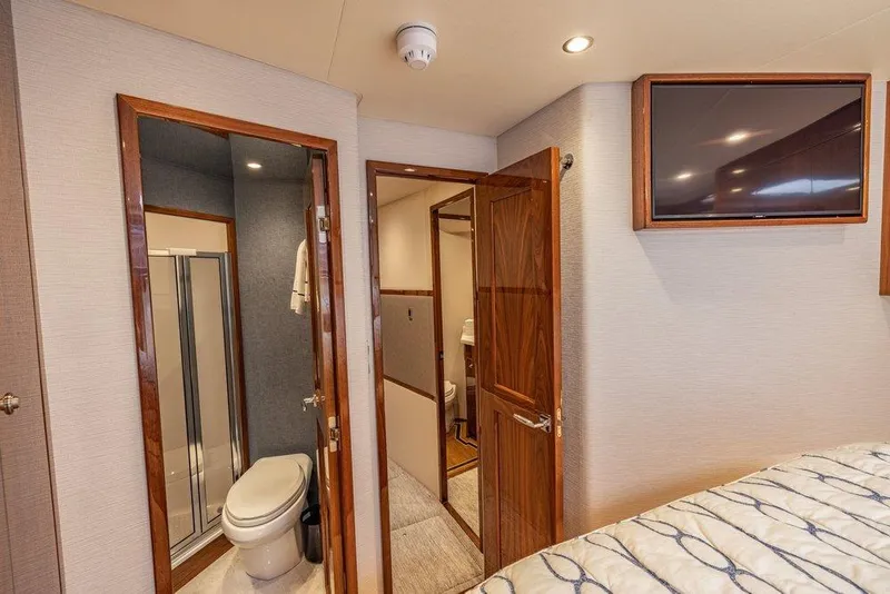 Slide: The Image of Interior of 2022 Viking 72 Convertible yacht with bathroom and TV. - 59
