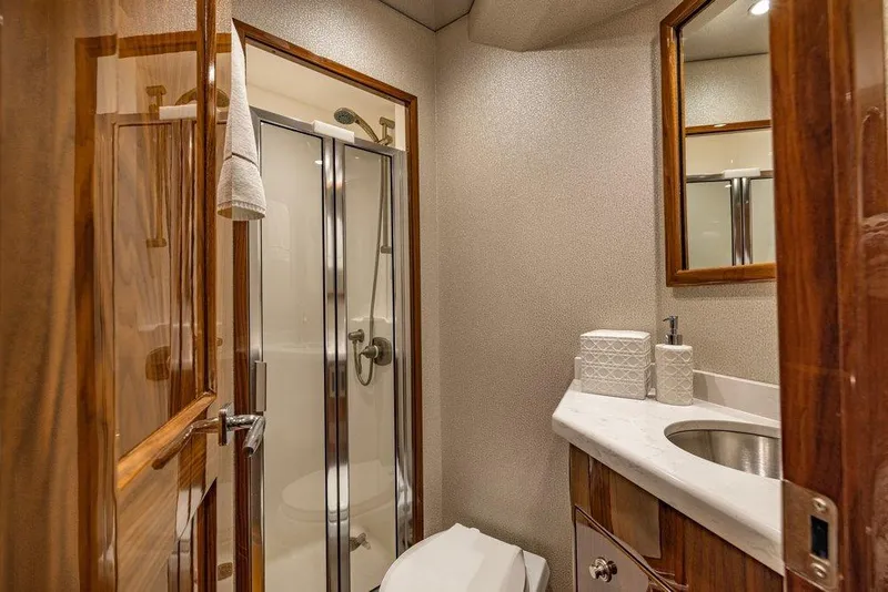 Slide: The Image of Luxurious bathroom in 2022 Viking 72 Convertible yacht with shower and elegant wood finishes. - 62