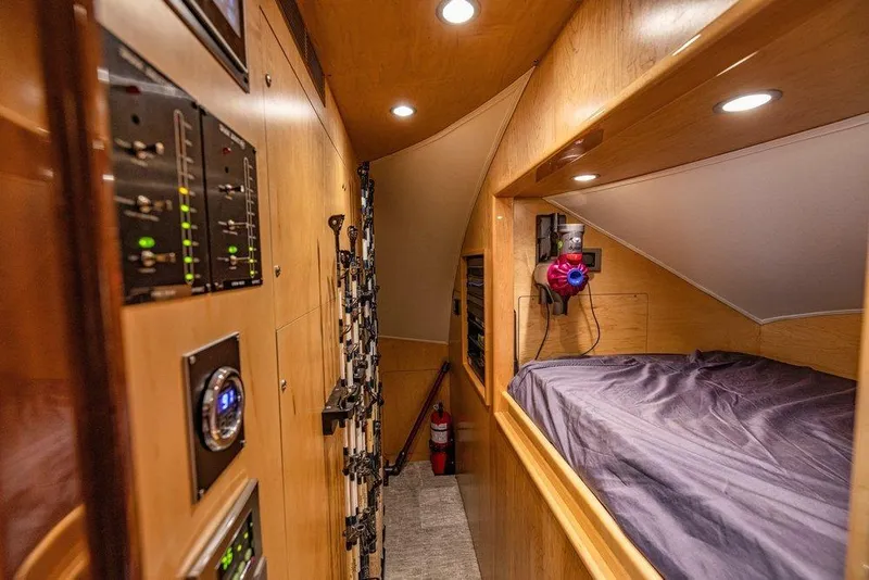 Slide: The Image of Interior of 2022 Viking 72 Convertible yacht with bunk bed and control panels. - 67