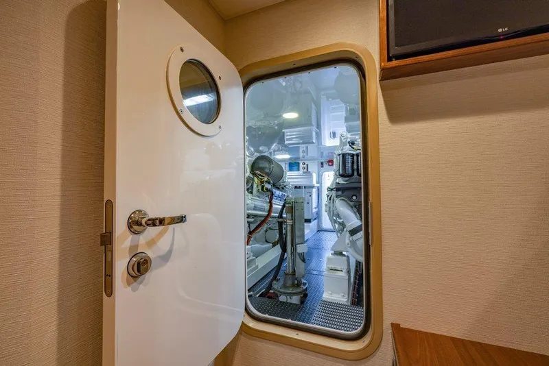 Slide: The Image of Engine room view of 2022 Viking 72 Convertible yacht through open door. - 68