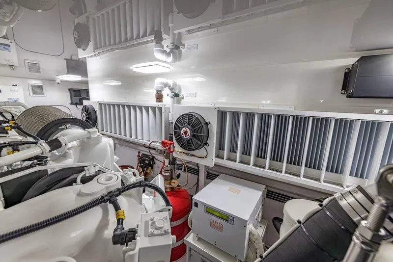 Slide: The Image of Engine room of 2022 Viking 72 Convertible yacht, featuring advanced machinery and ventilation systems. - 72