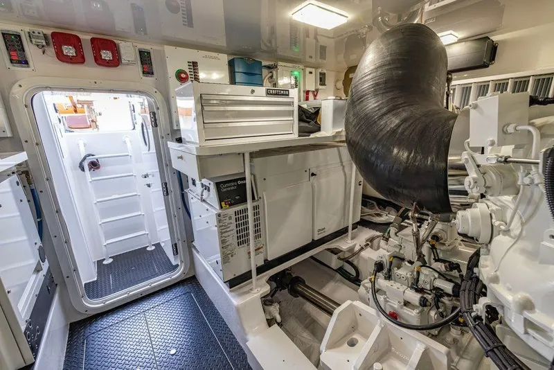 Slide: The Image of Engine room of 2022 Viking 72 Convertible yacht, featuring advanced machinery and equipment. - 73