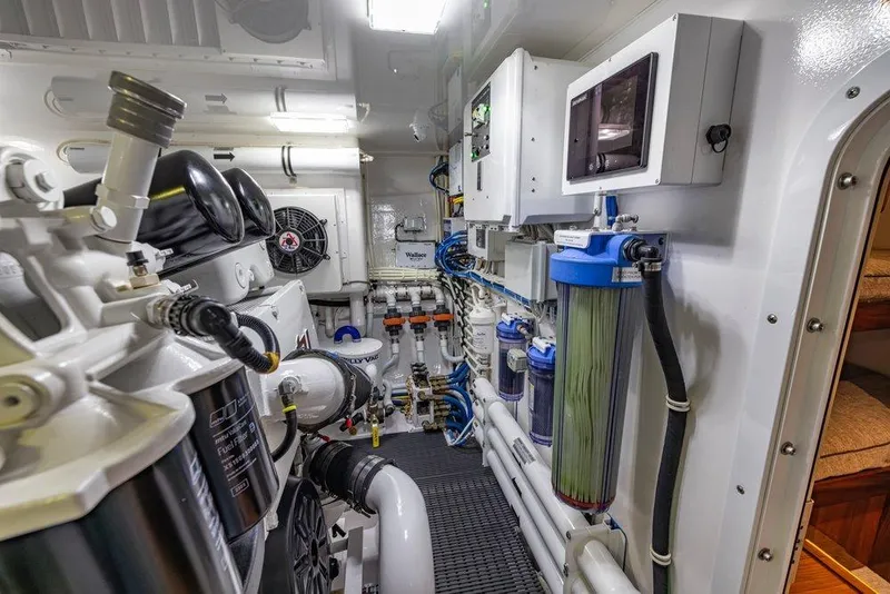 Slide: The Image of Engine room of 2022 Viking 72 Convertible yacht, showcasing advanced machinery and filtration systems. - 75