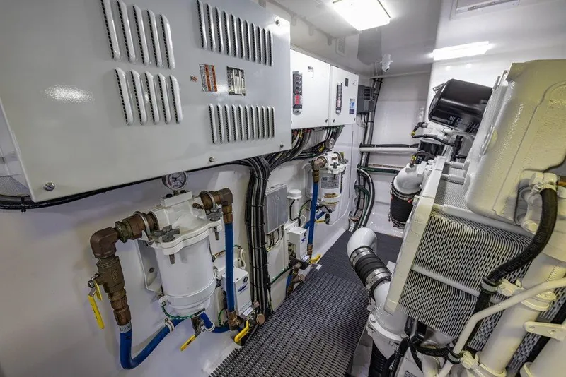 Slide: The Image of Engine room of 2022 Viking 72 Convertible yacht, showcasing advanced machinery and systems. - 76