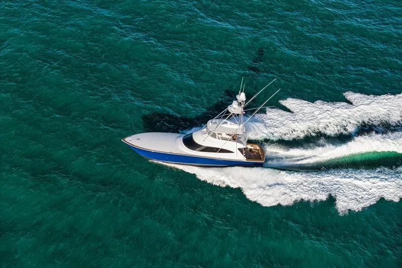 Slide: The Image of Aerial view of 2022 Viking 72 Convertible yacht cruising on turquoise waters. - 8