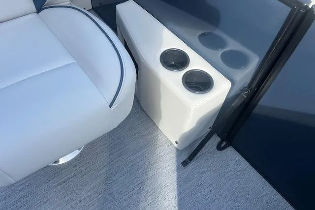 Slide: The Image of 2026 Godfrey Sweetwater 2286 SB boat interior with white seating and dual cup holders. - 16