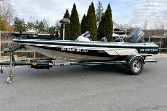 The Image of 2007 Skeeter SX170 fishing boat on trailer, parked on a paved road. - 1