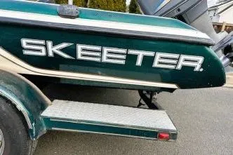 Slide: The Image of 2007 Skeeter SX170 boat with visible logo and trailer step. - 10