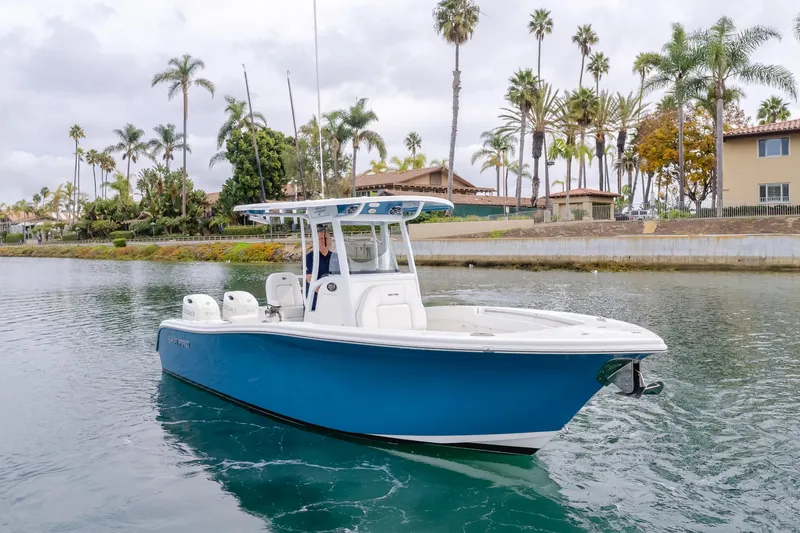Slide: The Image of 2020 Sea Prop center console boat on calm water with palm trees in background. - 1
