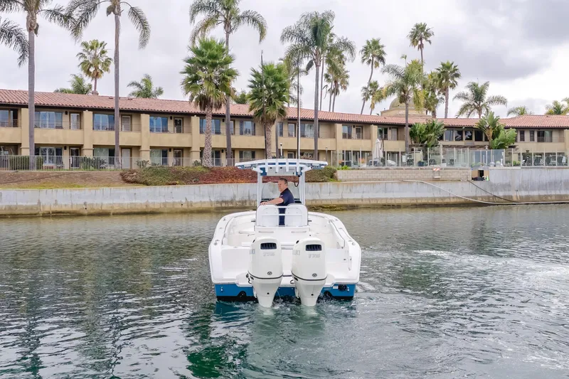 Slide: The Image of 2020 Sea Prop center console boat cruising near waterfront buildings and palm trees. - 3