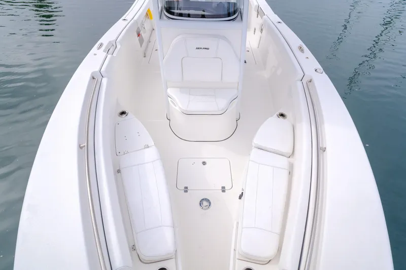 Slide: The Image of 2020 Sea Prop center console boat with white seating and sleek design on calm water. - 9