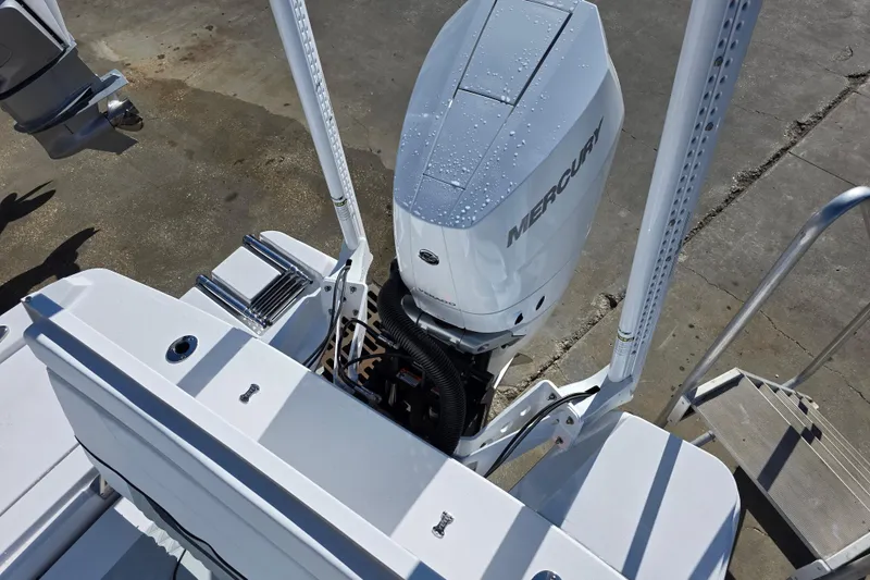 Slide: The Image of 2026 Blackfin 262 HB boat with Mercury outboard engine, docked on concrete surface. - 12