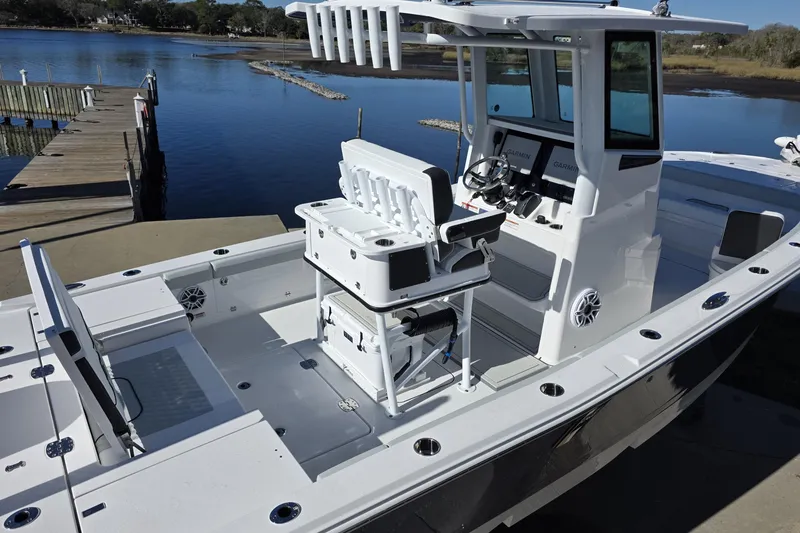 Slide: The Image of 2026 Blackfin 262 HB boat docked, featuring modern helm and seating. - 13