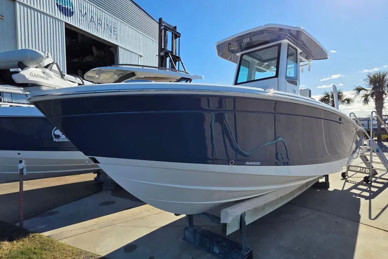 Slide: The Image of 2026 Blackfin 262 HB boat displayed outdoors at a marine facility. - 5