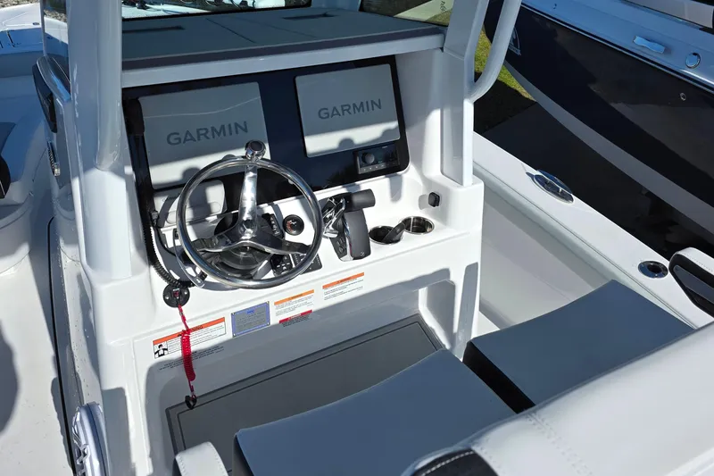 Slide: The Image of 2026 Blackfin 262 HB boat helm with dual Garmin displays and modern steering wheel. - 8