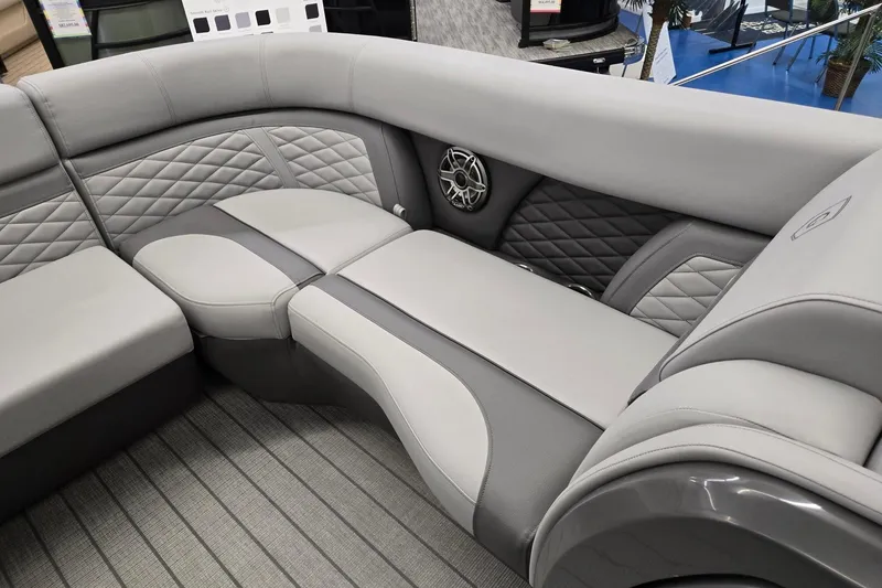 Slide: The Image of Luxurious seating on 2026 Godfrey Monaco 235 QSB boat, featuring quilted upholstery and integrated speaker. - 11