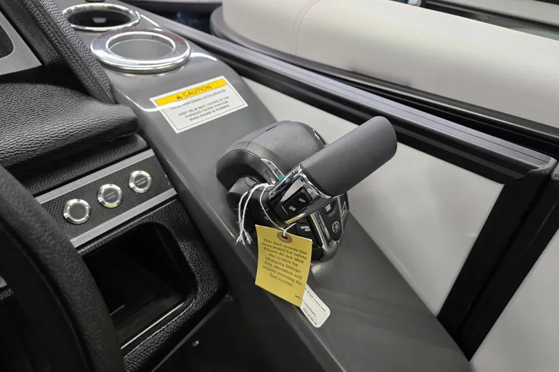 Slide: The Image of Control panel of 2026 Godfrey Monaco 235 QSB boat with throttle and cup holders. - 20