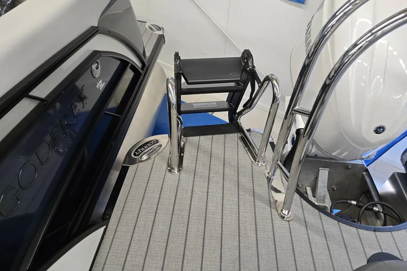 Slide: The Image of 2026 Godfrey Monaco 235 QSB boat with swim ladder and sleek deck design. - 26