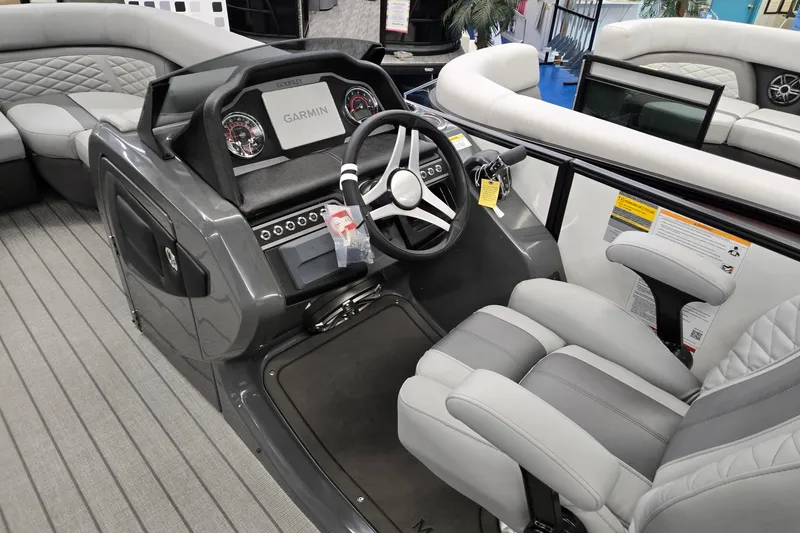 Slide: The Image of 2026 Godfrey Monaco 235 QSB boat interior with steering wheel and seating. - 32