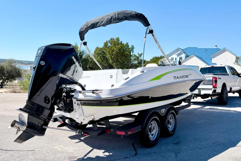 Slide: The Image of 2023 Tahoe 2150 boat on trailer, featuring a powerful Mercury outboard motor. - 13