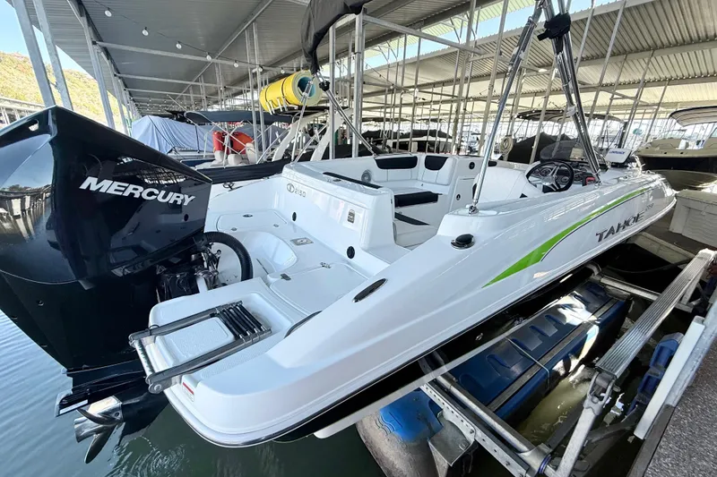 Slide: The Image of 2023 Tahoe 2150 boat with Mercury engine docked in a marina. - 19
