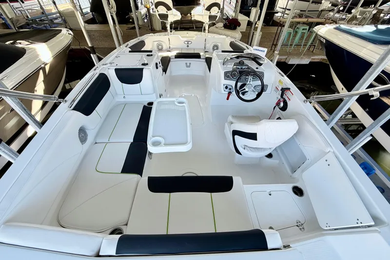 Slide: The Image of 2023 Tahoe 2150 boat interior with seating, steering wheel, and control panel. - 23