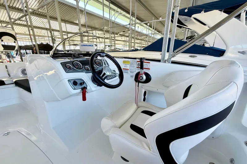 Slide: The Image of 2023 Tahoe 2150 boat interior with steering wheel and control panel. - 26