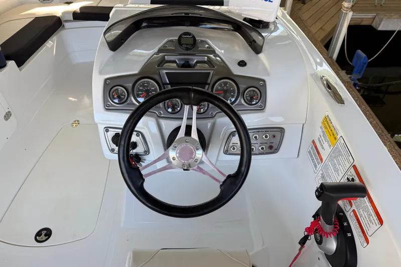 Slide: The Image of 2023 Tahoe 2150 boat dashboard with steering wheel and control panel. - 27