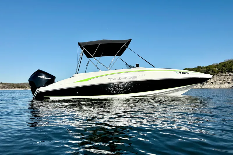 Slide: The Image of 2023 Tahoe 2150 boat on calm water with clear blue sky. - 3