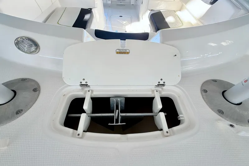 Slide: The Image of 2023 Tahoe 2150 boat anchor storage compartment with open lid, showcasing interior design. - 31