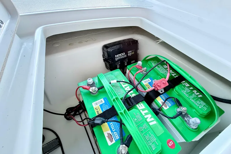 Slide: The Image of 2023 Tahoe 2150 boat battery compartment with NOCO Genius charger and Interstate batteries. - 32