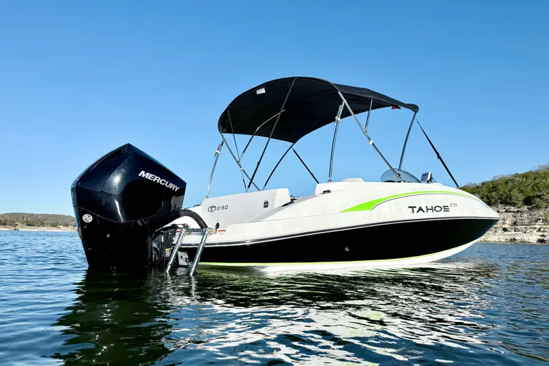 Slide: The Image of 2023 Tahoe 2150 boat with Mercury engine on a sunny lake. - 4