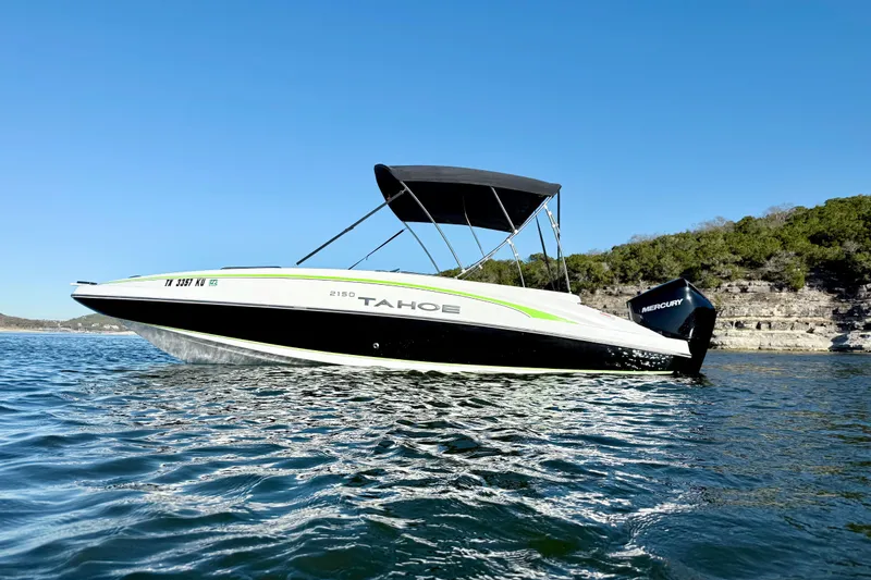 Slide: The Image of 2023 Tahoe 2150 boat on water with Mercury engine, clear blue sky. - 7
