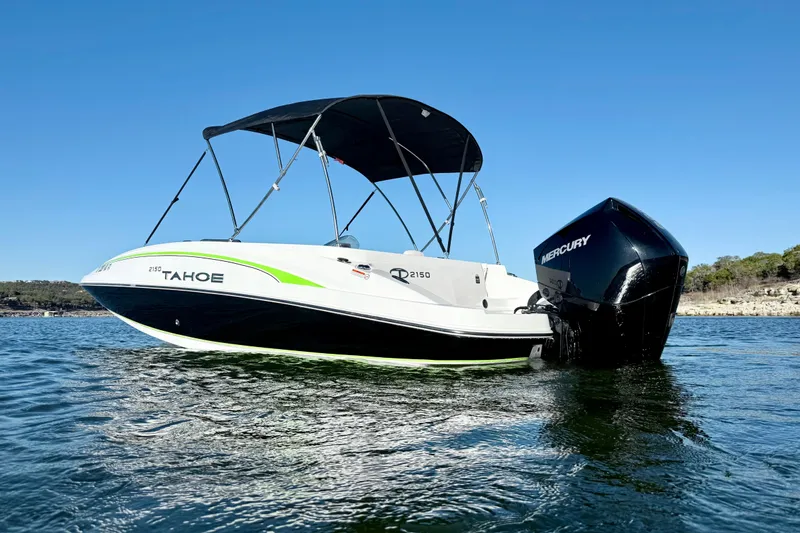 Slide: The Image of 2023 Tahoe 2150 boat with Mercury engine on a clear blue lake. - 8