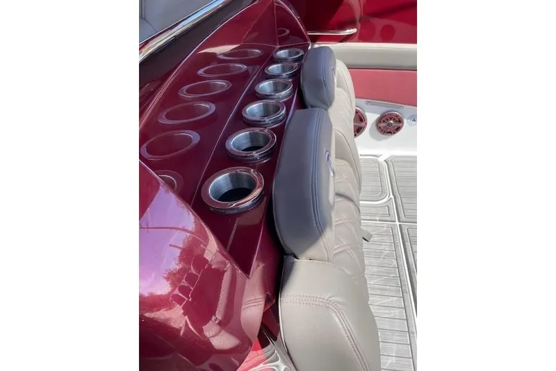 Slide: The Image of 2021 Mystic Powerboats M3800 interior with cup holders and cushioned seating. - 18