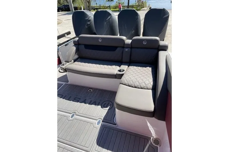 Slide: The Image of 2021 Mystic Powerboats M3800 interior with luxurious seating and cup holders. - 19