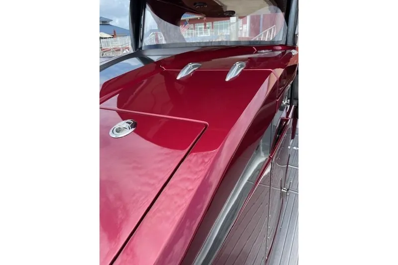 Slide: The Image of 2021 Mystic Powerboats M3800, sleek red deck with chrome accents. - 24