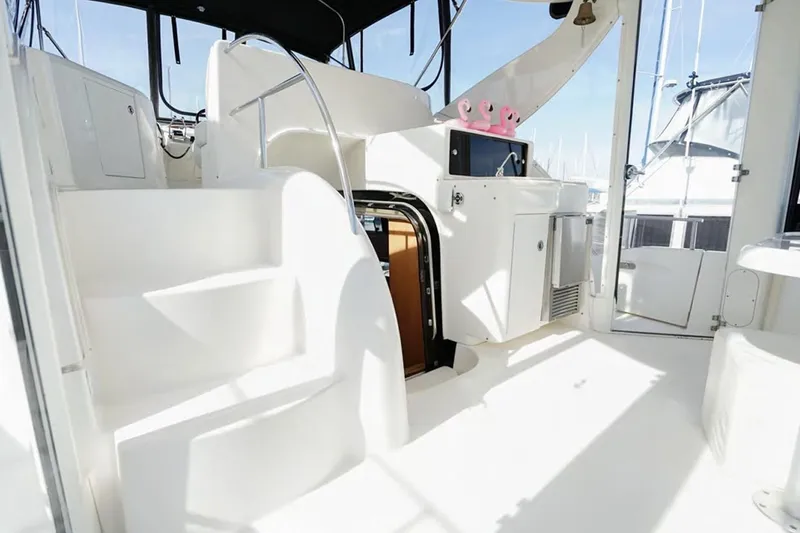 Slide: The Image of 2004 Meridian 459 Motoryacht interior with stairs, kitchenette, and bright white finish. - 15