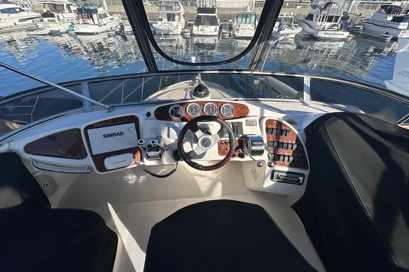 Slide: The Image of 2004 Meridian 459 Motoryacht helm with navigation equipment and marina view. - 6