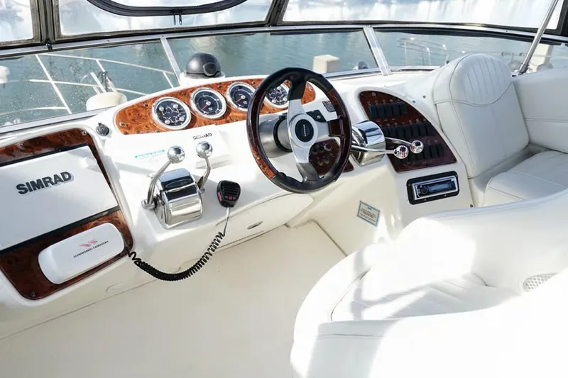 Slide: The Image of 2004 Meridian 459 Motoryacht helm with Simrad navigation and luxurious white seating. - 7