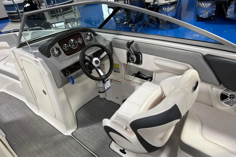 Slide: The Image of 2020 Chaparral 23 SSi boat interior with steering wheel and dashboard controls. - 10