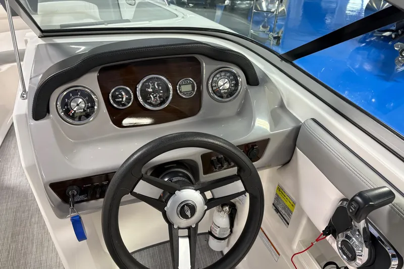 Slide: The Image of 2020 Chaparral 23 SSi boat dashboard with steering wheel and gauges. - 11