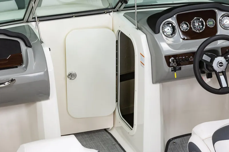 Slide: The Image of Manufacturer Provided Image: 2020 Chaparral 23 SSi boat interior with open storage compartment and dashboard. - 16