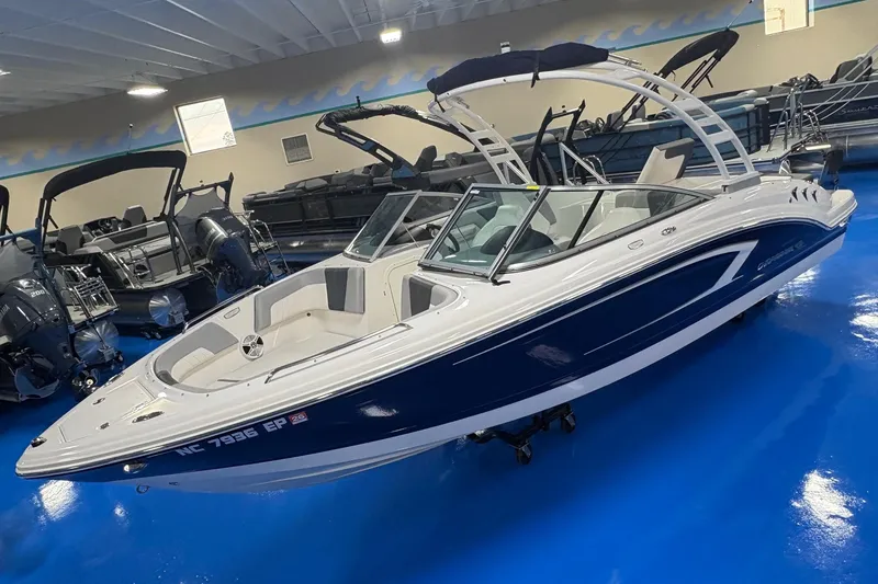 Slide: The Image of 2020 Chaparral 23 SSi boat displayed in showroom with blue flooring. - 4
