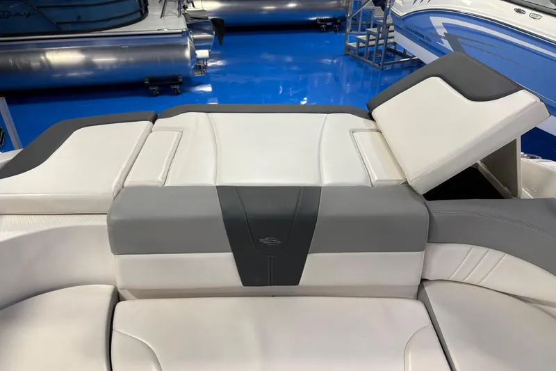 Slide: The Image of 2020 Chaparral 23 SSi boat interior with white and gray seating, showroom display. - 7