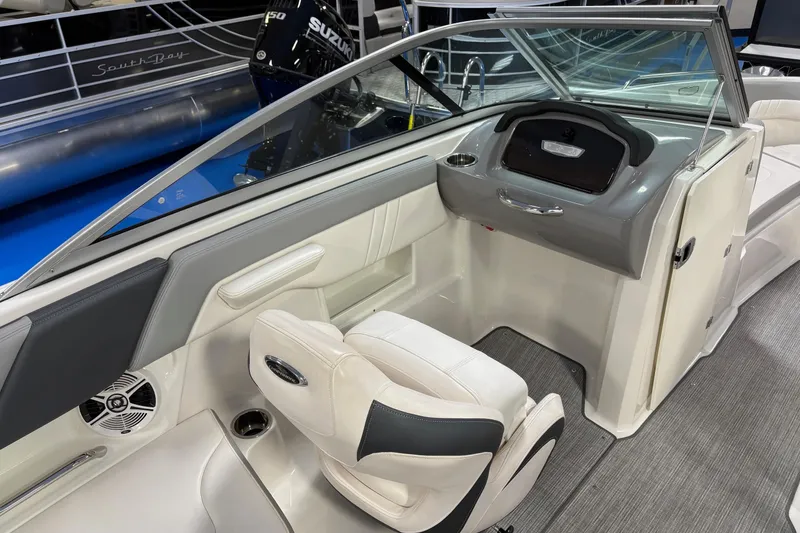 Slide: The Image of 2020 Chaparral 23 SSi boat interior with helm, seating, and dashboard. - 9
