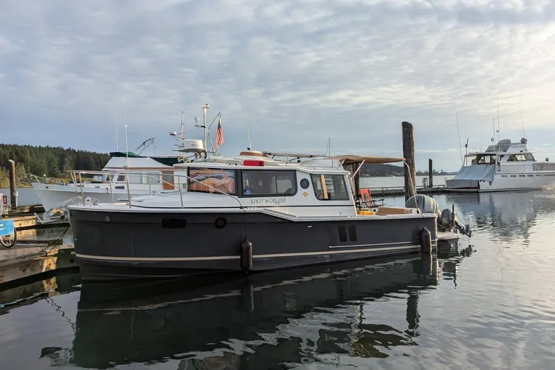 The Image of 2020 Ranger Tugs R-27 boat docked in a serene marina setting. - 0