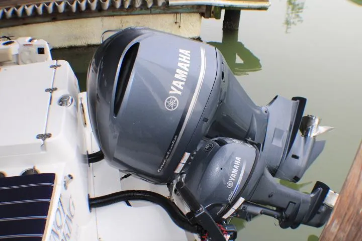 Slide: The Image of Yamaha outboard motors on a 2020 Ranger Tugs R-27 boat, docked by the water. - 10